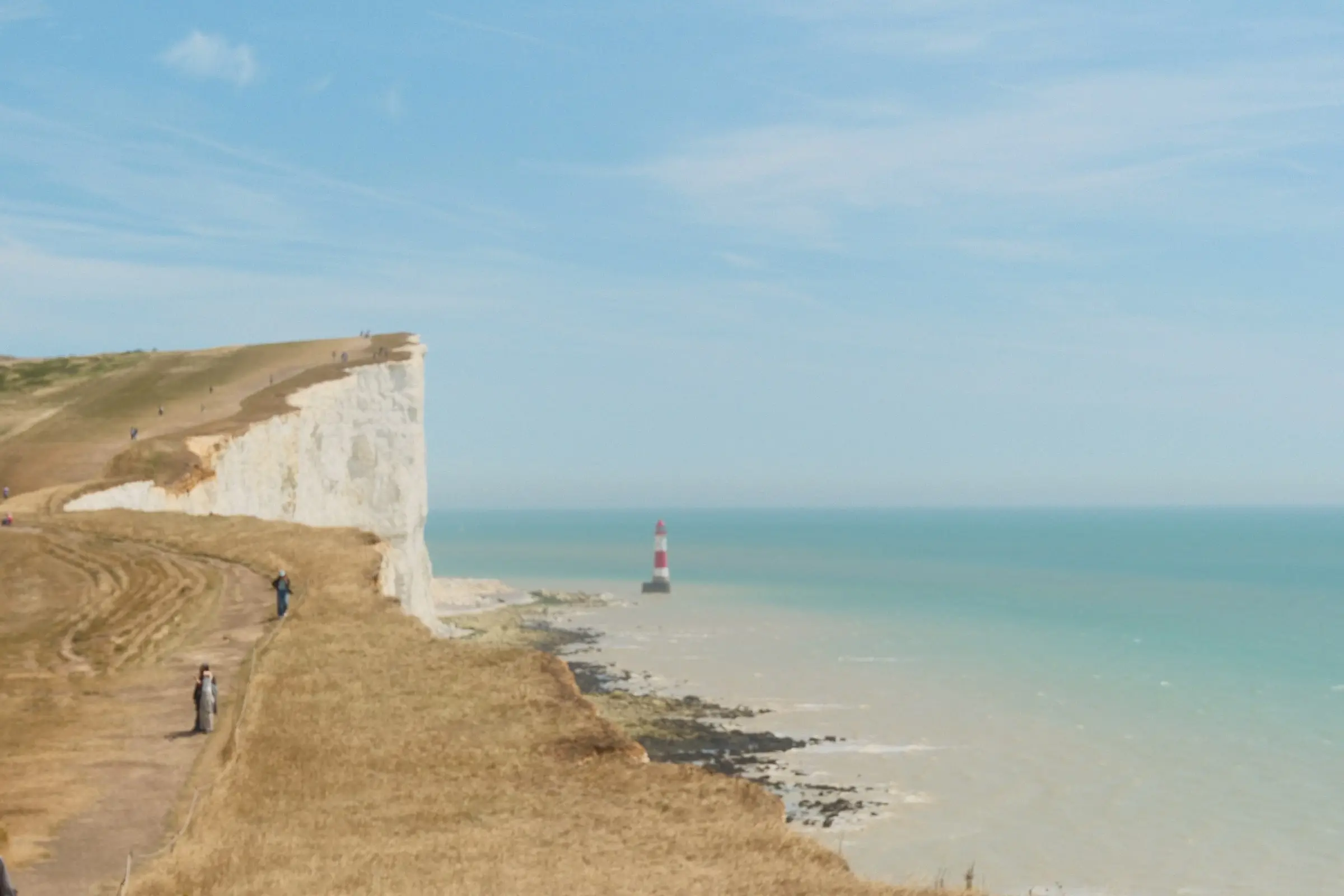 White chalk cliffs and a lighthouse by the sea — Seven Sisters